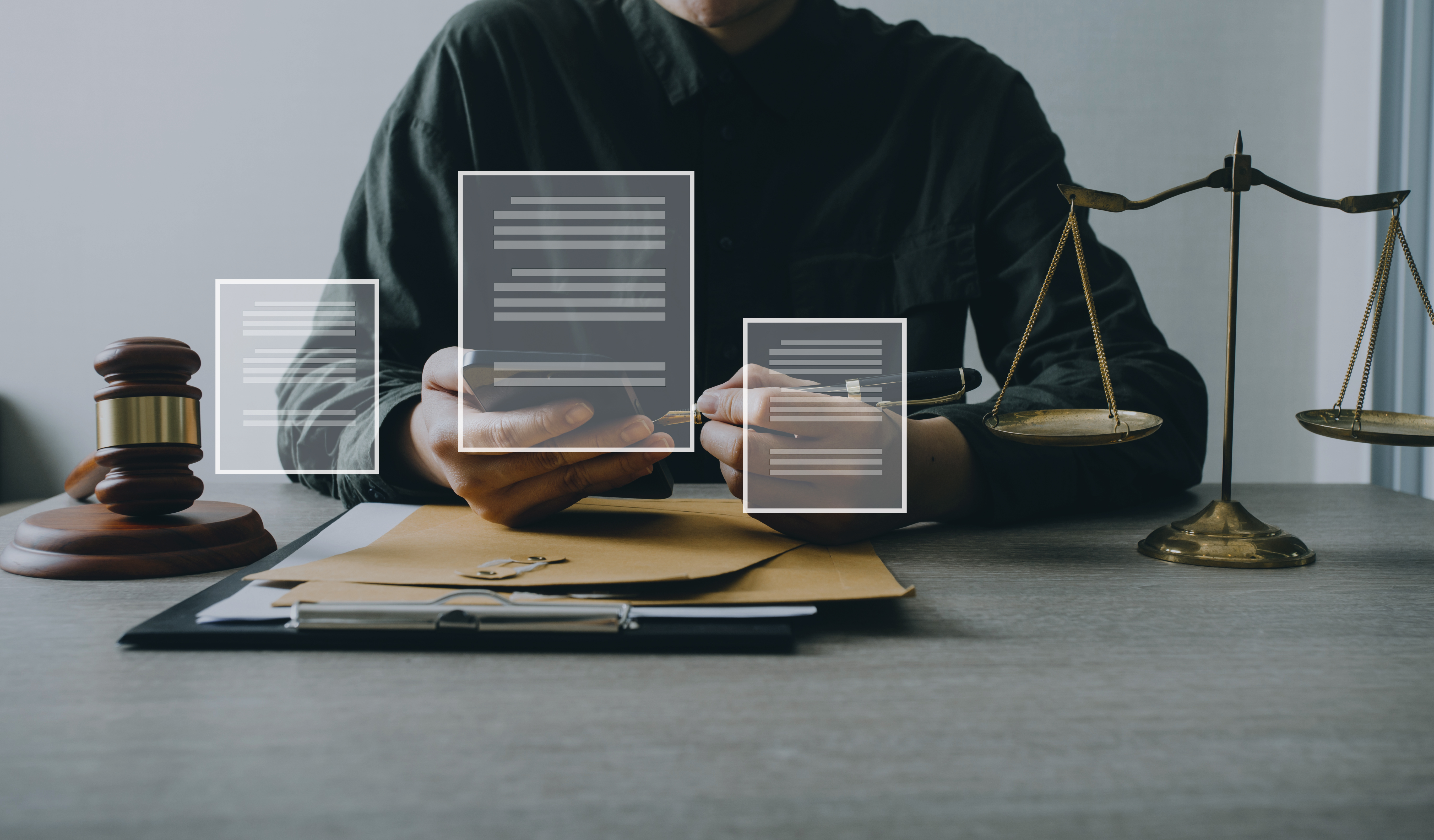 Male lawyer working with contract papers and wooden gavel on tab digital contracts